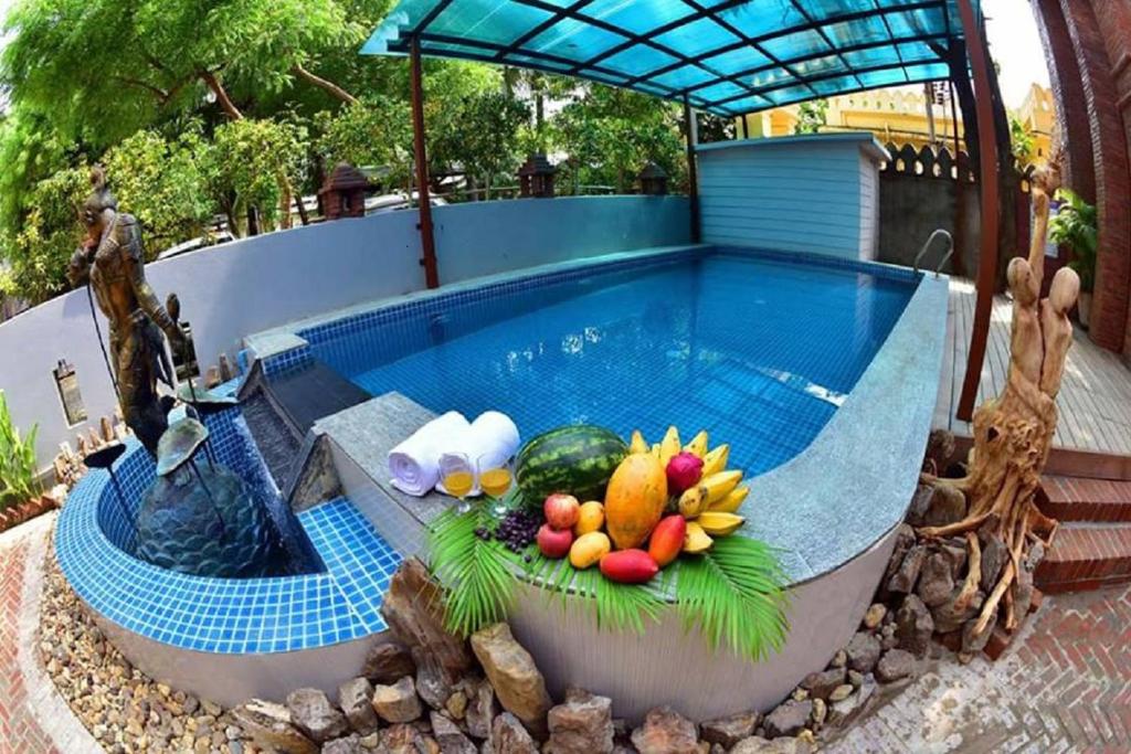 a swimming pool with a bowl of fruit on top of it at Northern Breeze Hotel in Bagan