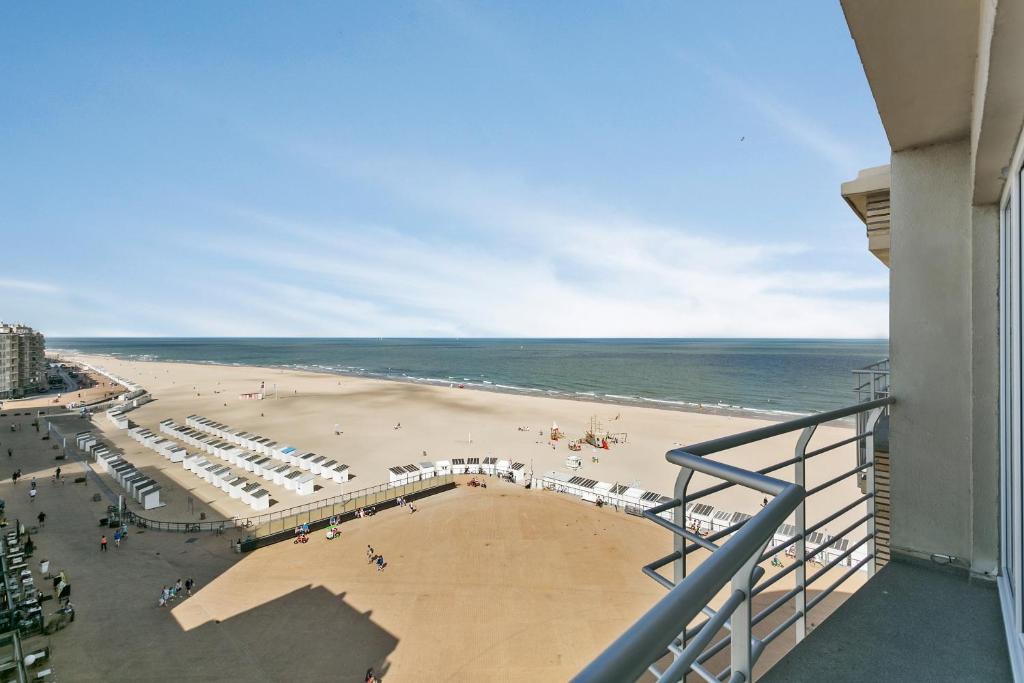 a view of the beach from the balcony of a building at Apartment V7 in Ostend