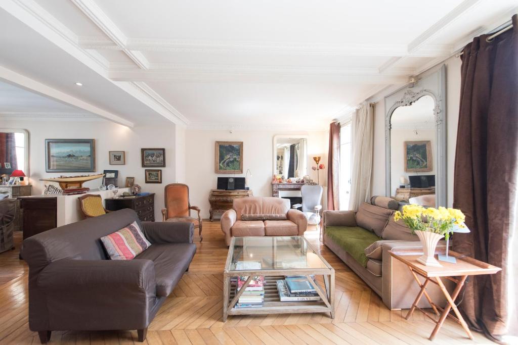 a living room with two couches and a table at Veeve - Musical retreat in the 15th in Paris