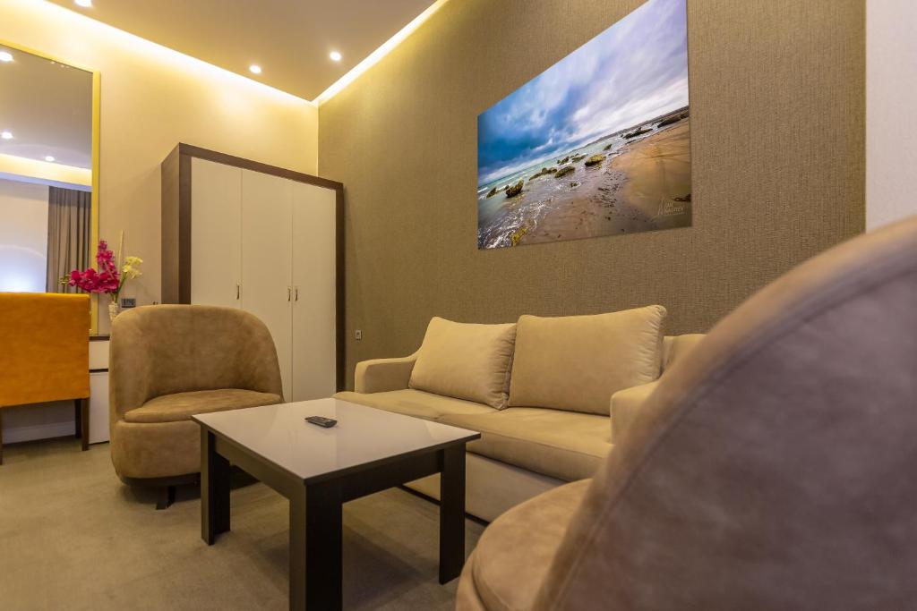 a living room with a couch and a table at Aksent Hotel in Baku