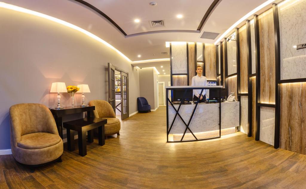 a salon with a table and chairs in a room at Aksent Hotel in Baku