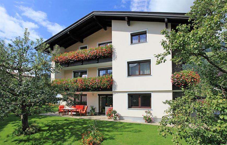 a large white building with flowers on it at Haus Heckenrose in Westendorf