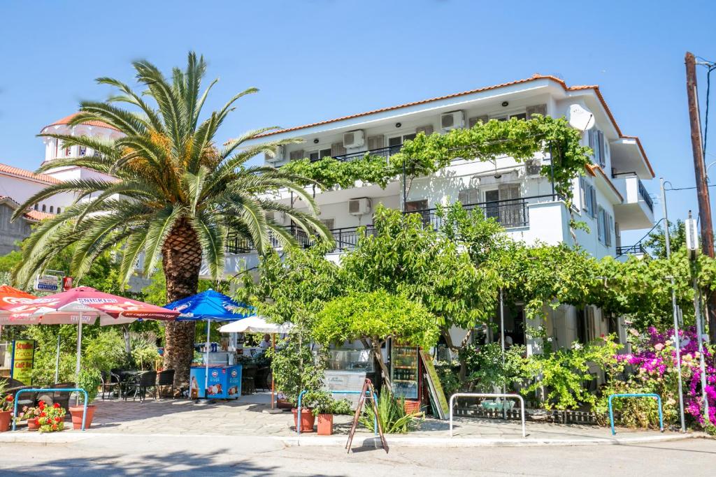 un bâtiment avec un palmier en face dans l'établissement Francesca Studios, à Potos