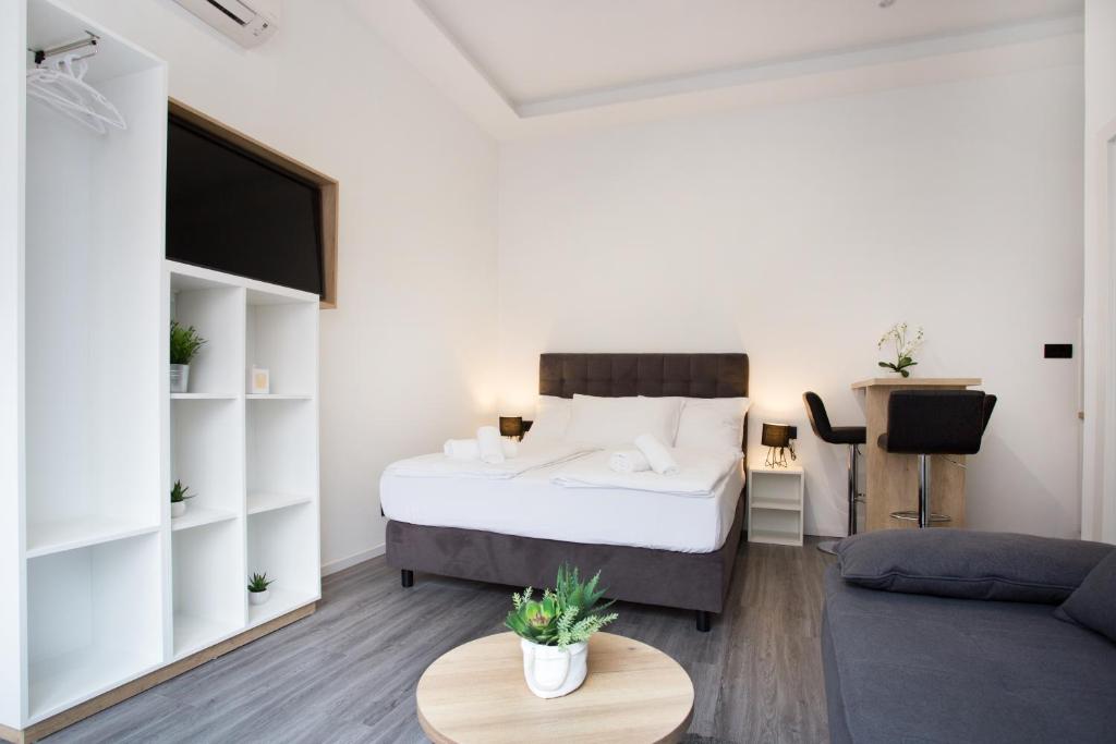a bedroom with a bed and a living room at SENZACIJA apartments in Split