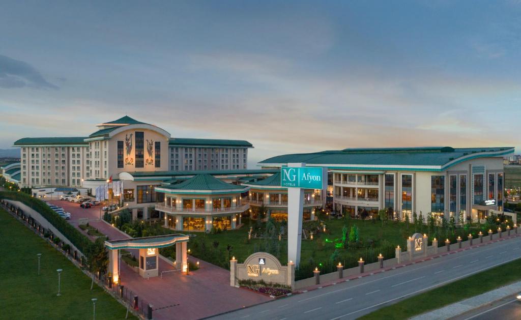 a large building with a street sign in front of it at NG Afyon Wellness & Convention in Afyon