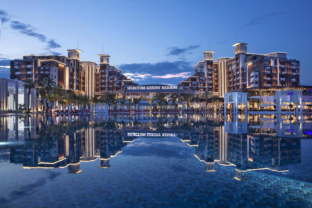 a rendering of a resort with its reflection in the water at Selectum Luxury Resort Belek in Belek