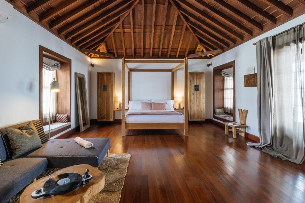 a living room with a couch and a bed at Hotel Boutique Palacio Ico - Only Adults in Teguise