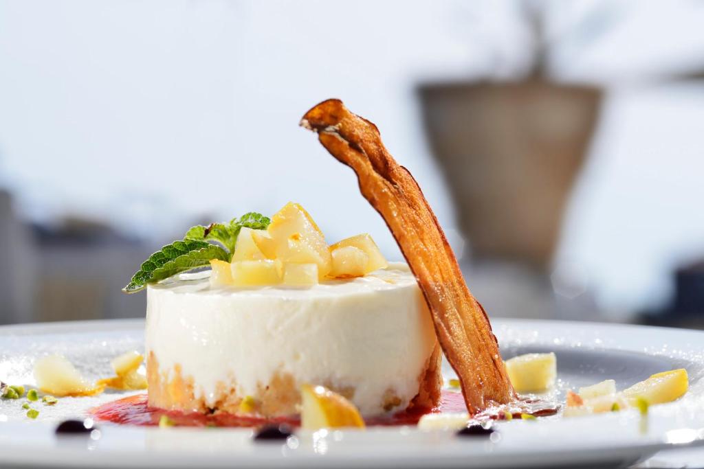 a piece of cake with a stick on a plate at Villa delle Palme in Santa Marinella