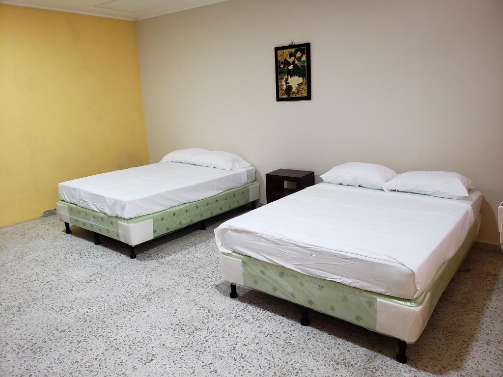 Postel nebo postele na pokoji v ubytování Hotel El Dorado