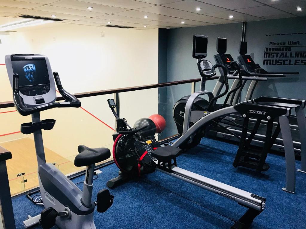 a gym with two treadmills and a treadmill at Cumberland Hotel - OCEANA COLLECTION in Bournemouth