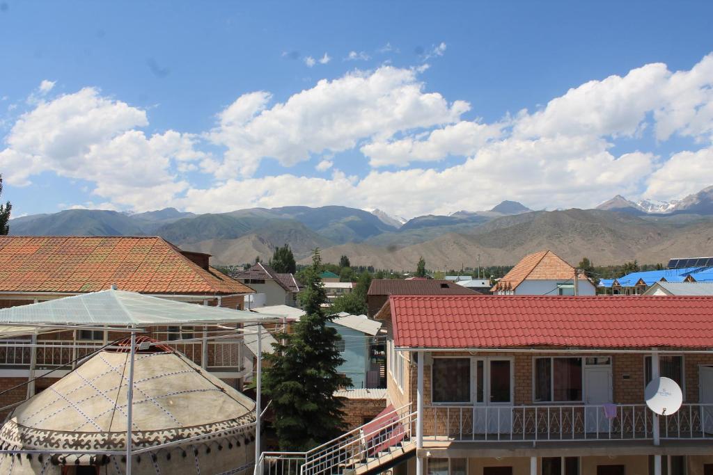 a view of a town with mountains in the background at Адилет in Cholpon-Ata