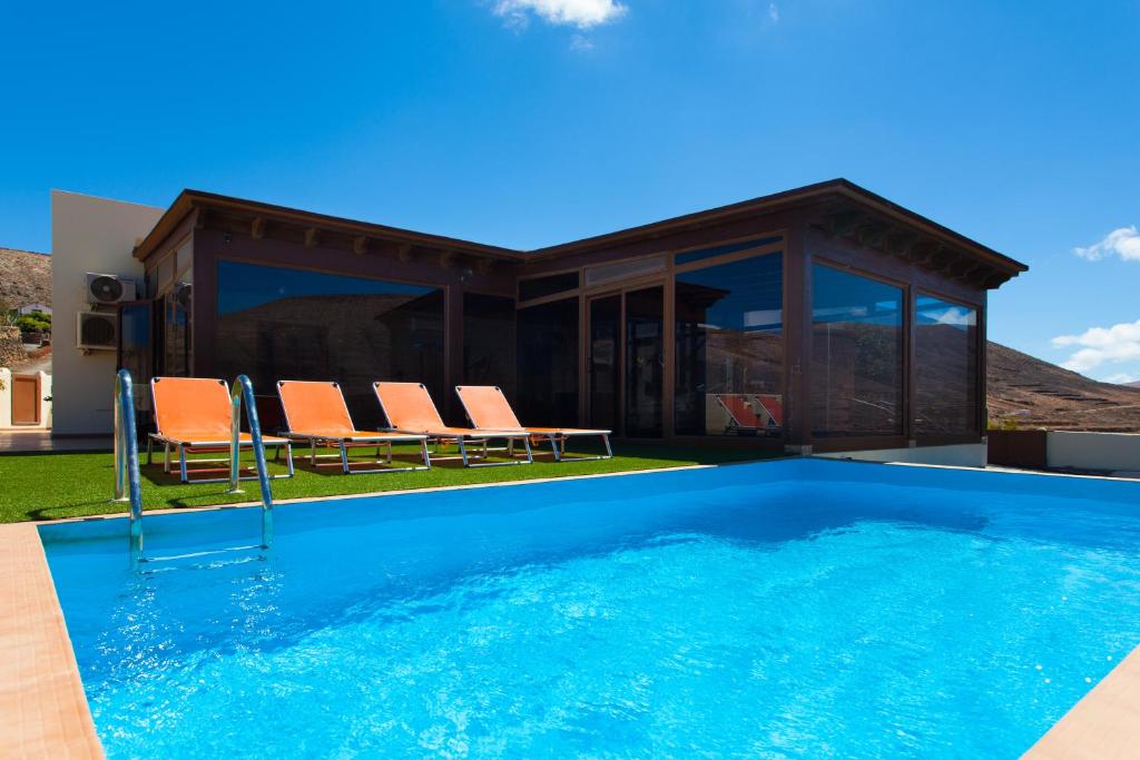 a swimming pool in front of a house at Casa Guisguey in Guisguey