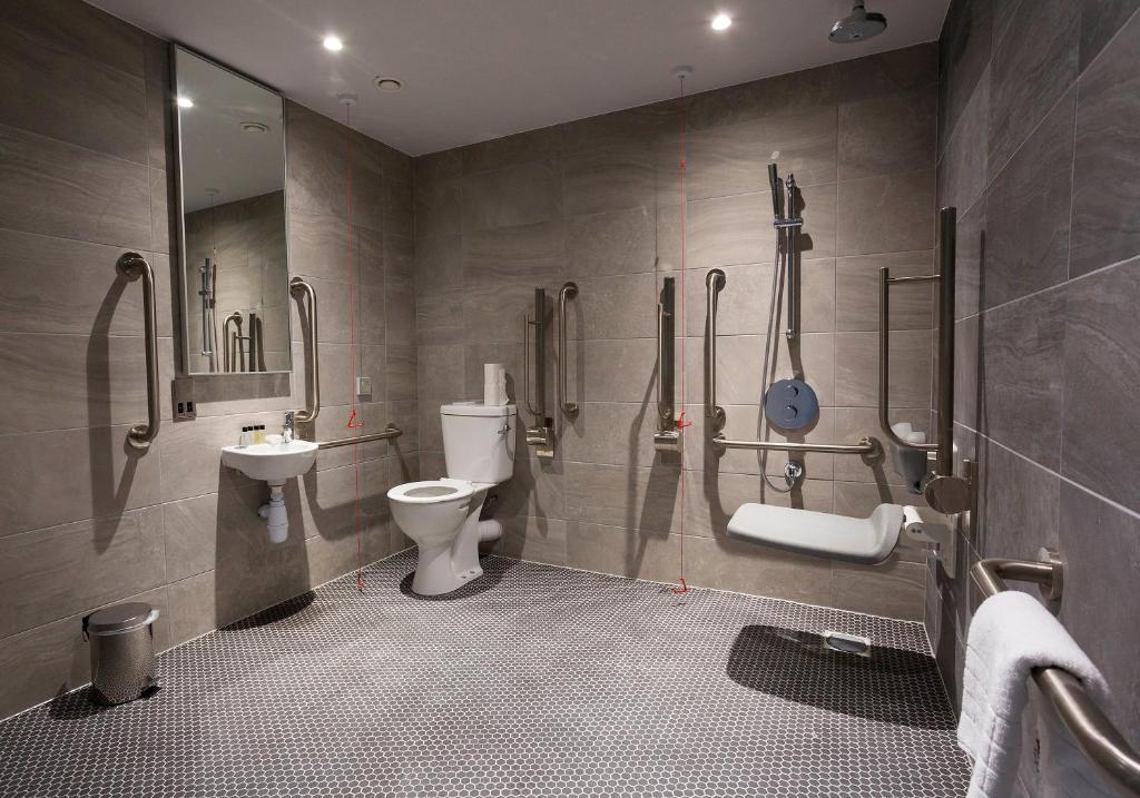 a bathroom with a toilet and a sink at Maldron Hotel Kevin Street, Dublin City in Dublin