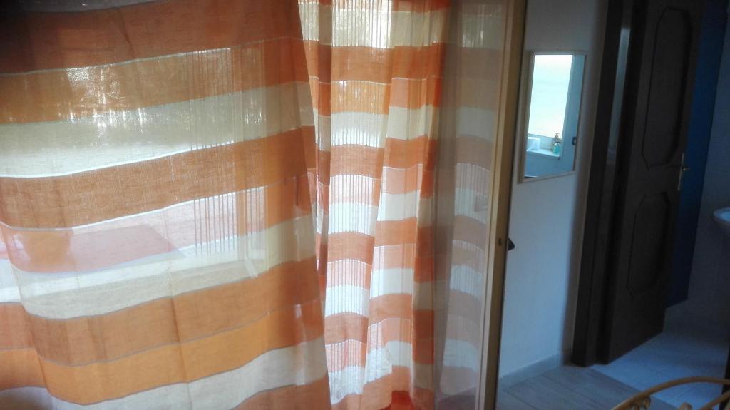 a shower curtain in a room with a window at La Pinetina in Soverato Marina