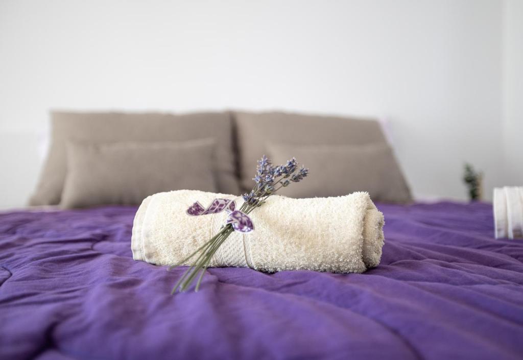 a towel with a bouquet of flowers on a bed at Nauportus in Vrhnika