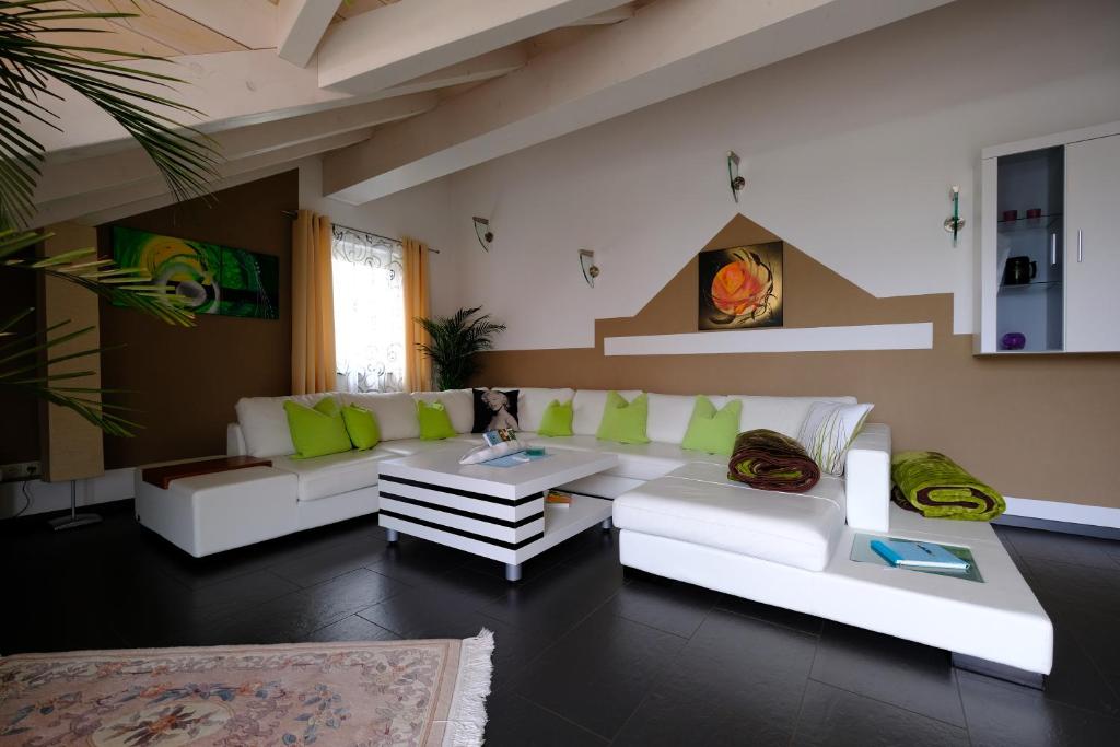 a living room with a white couch and a table at Ferienwohnung Henry im schönen Allgäu in Westendorf