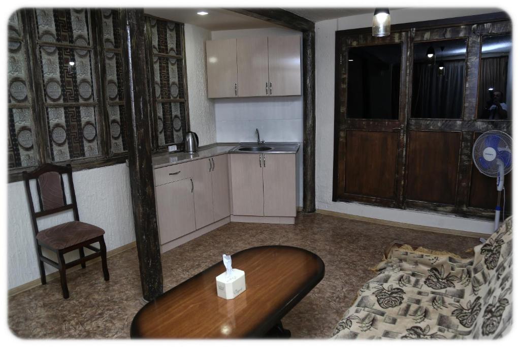 a small kitchen with a table and a chair at Lucy B&B in Goris