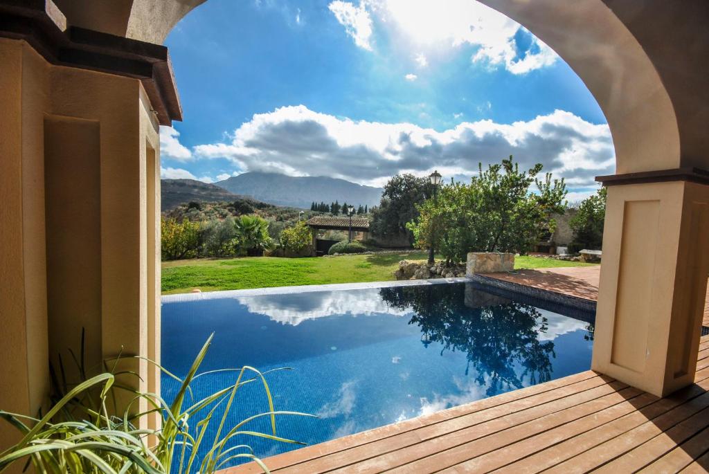 a swimming pool in a house with an archway at Mirador del Torcal in Antequera