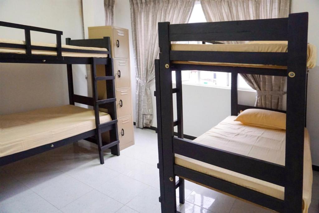 Postel nebo postele na pokoji v ubytování White Rose Hostel