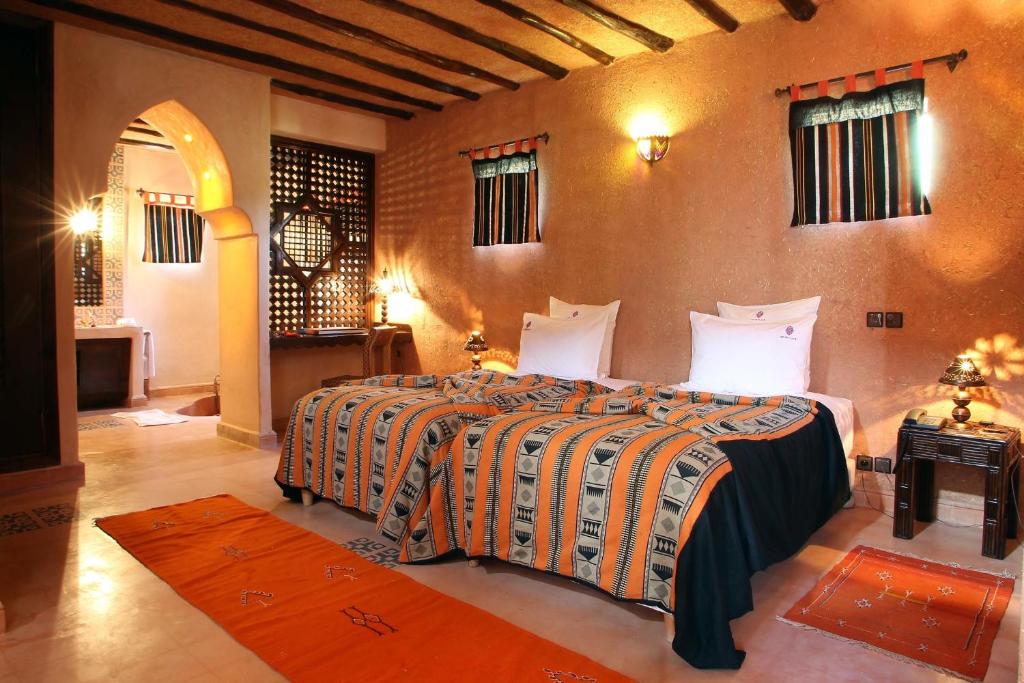 a bedroom with a large bed in a room at O'Atlas in El Harkat