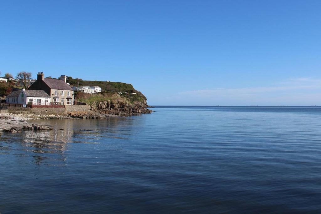 a house on an island in the middle of the water at Bungalow33 Benllech in Benllech