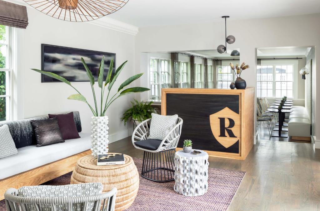 a living room with a couch and chairs and a table at The Richard, The Edgartown Collection in Edgartown