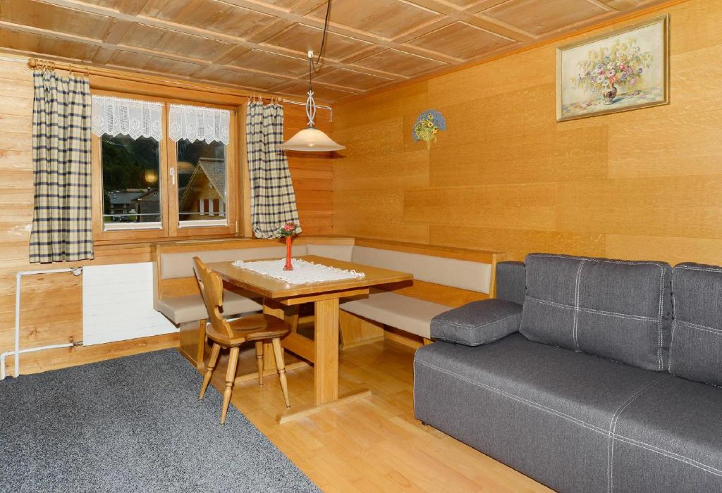 a living room with a couch and a table at Bauernhof Madlener Claudia in Schoppernau