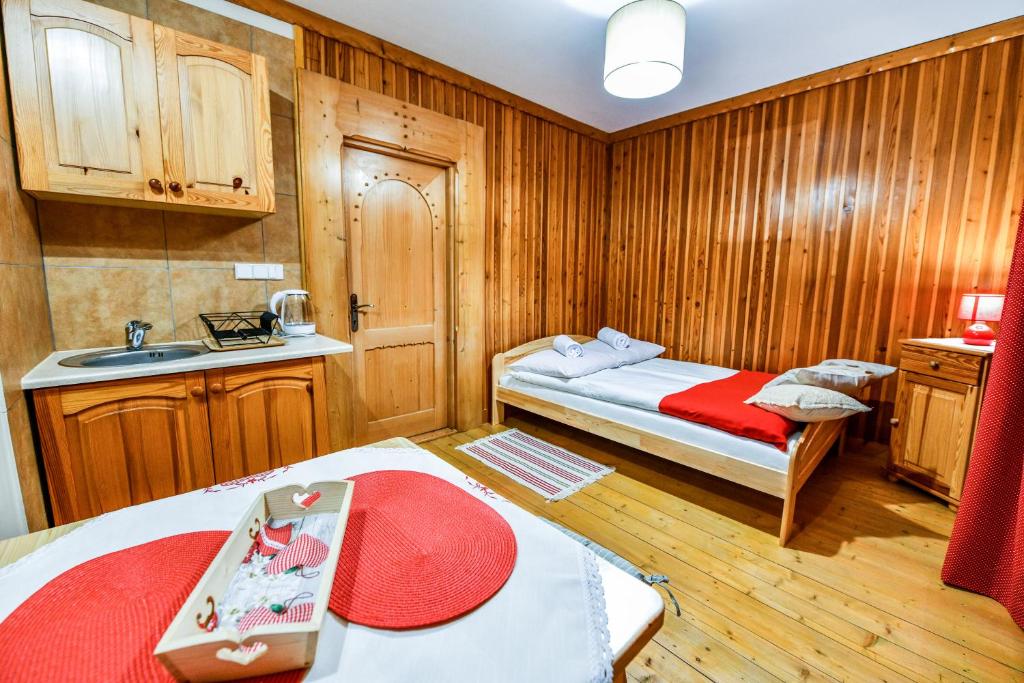 Kleines Zimmer mit 2 Betten und einem Waschbecken. in der Unterkunft Pokoje Gościnne Makuszyńskiego in Zakopane