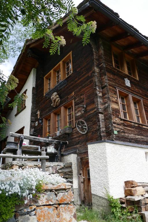 a wooden house with windows on the side of it at Châlet Birkhahn in Saas-Fee