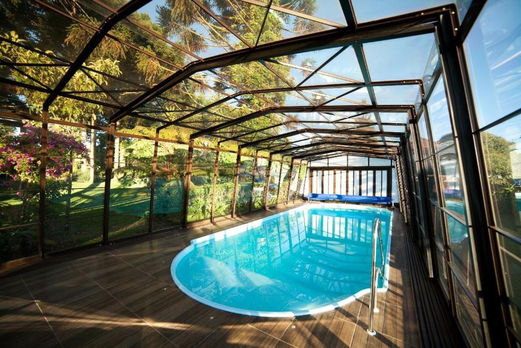 a swimming pool in a glass house at Pousada Vollweiter in Entre Rios