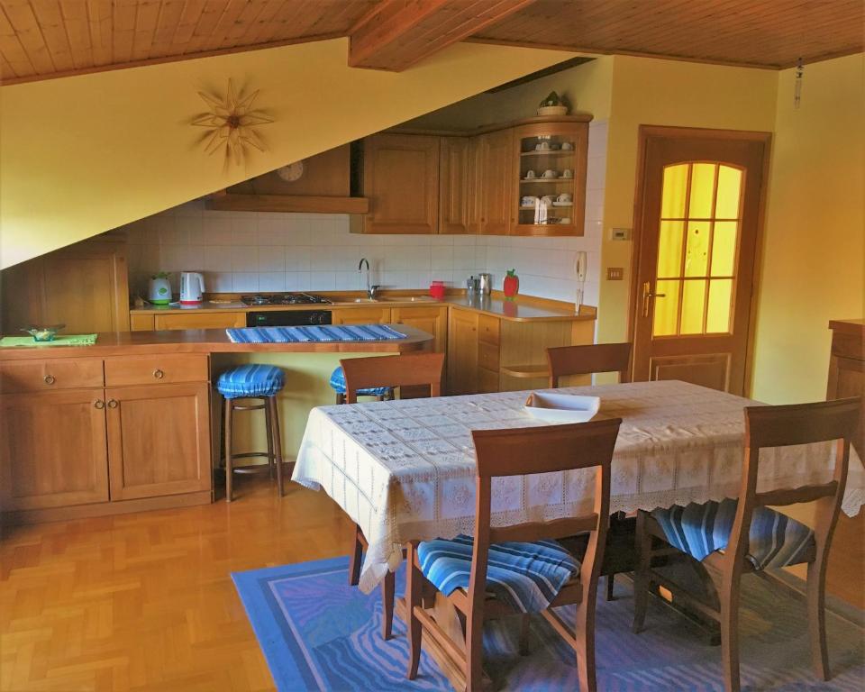 a kitchen with a table and chairs and a table and a kitchen at Appartamento Gorgotto in Gravedona