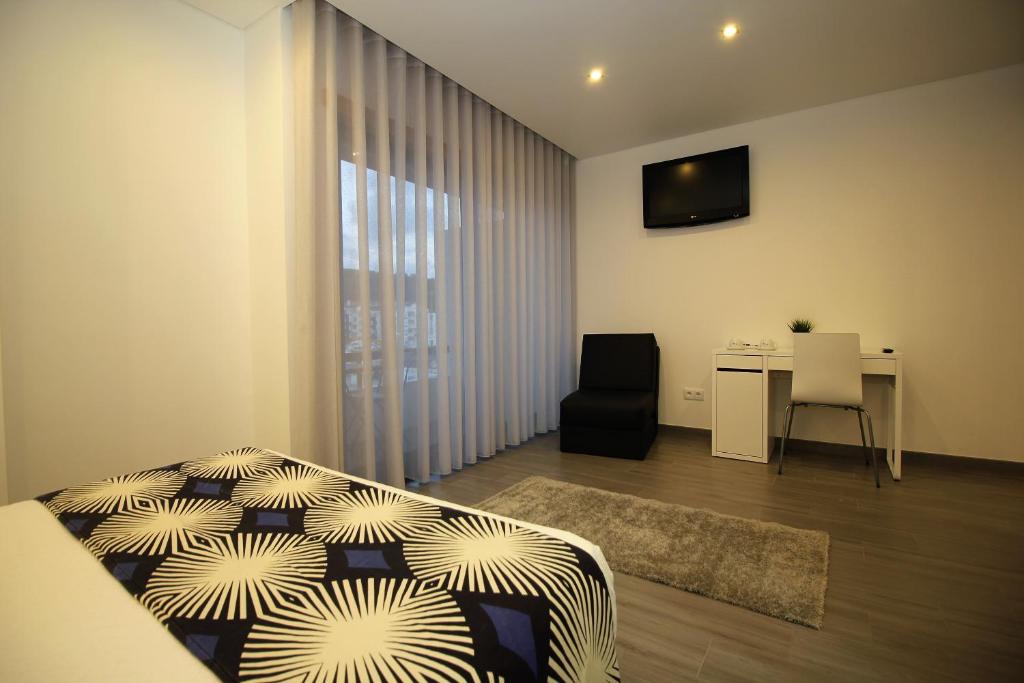 TV a/nebo společenská místnost v ubytování Gaivota Holidays