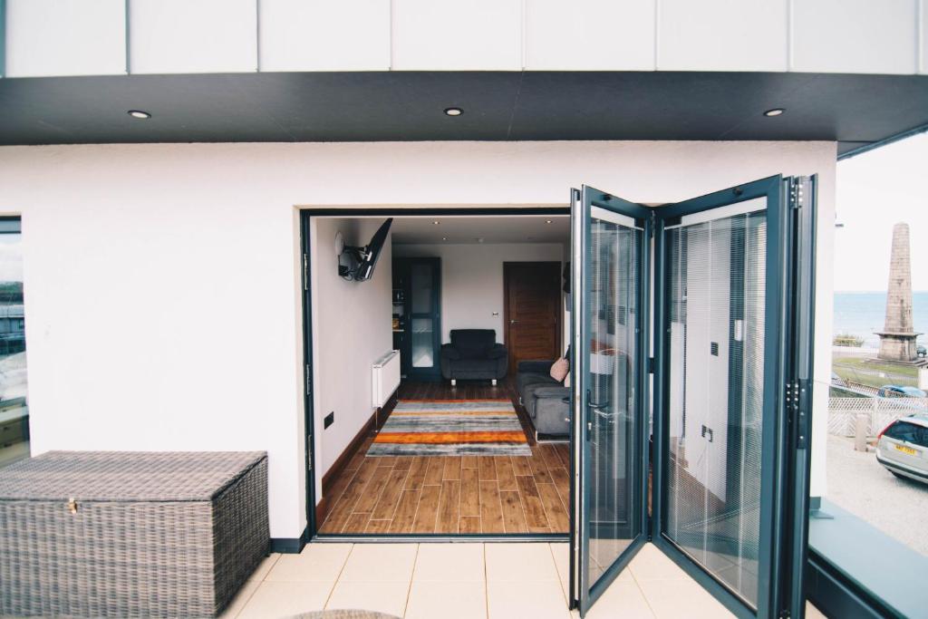 a room with glass doors leading to a living room at Antrim House Guest Rooms & Suites in Portrush