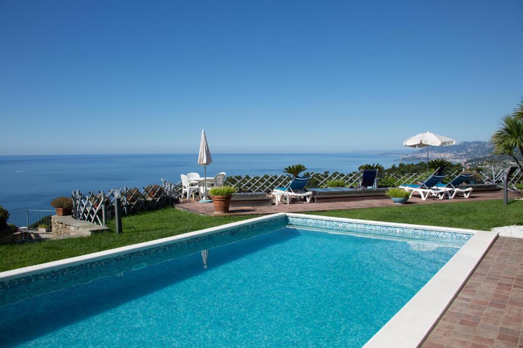 a swimming pool with a view of the ocean at Villa Montefontane in Camporosso