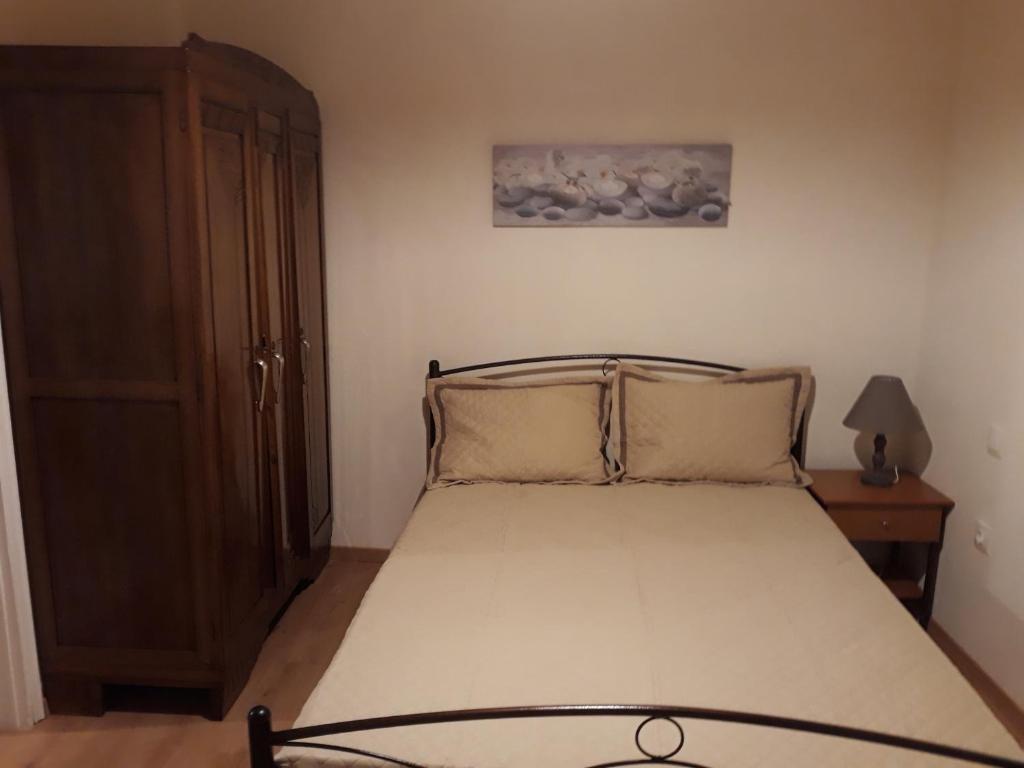 Postel nebo postele na pokoji v ubytování Atrium - Lafkos