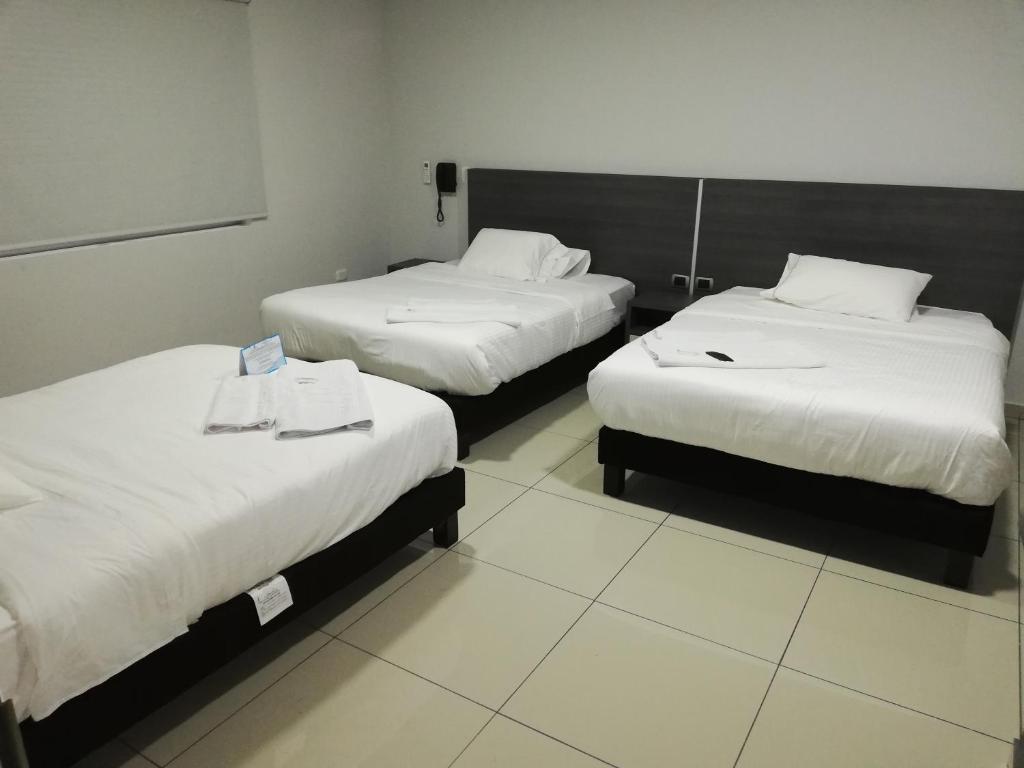 Postel nebo postele na pokoji v ubytování Hotel Doral Inn
