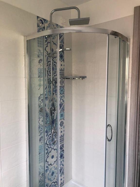 a shower with a glass door in a bathroom at Nereide in Tropea