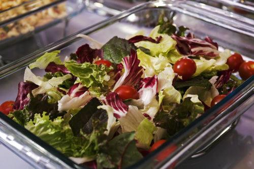 a salad with lettuce and tomatoes in a glass tray at Boutique Hotel Loft in Seoul