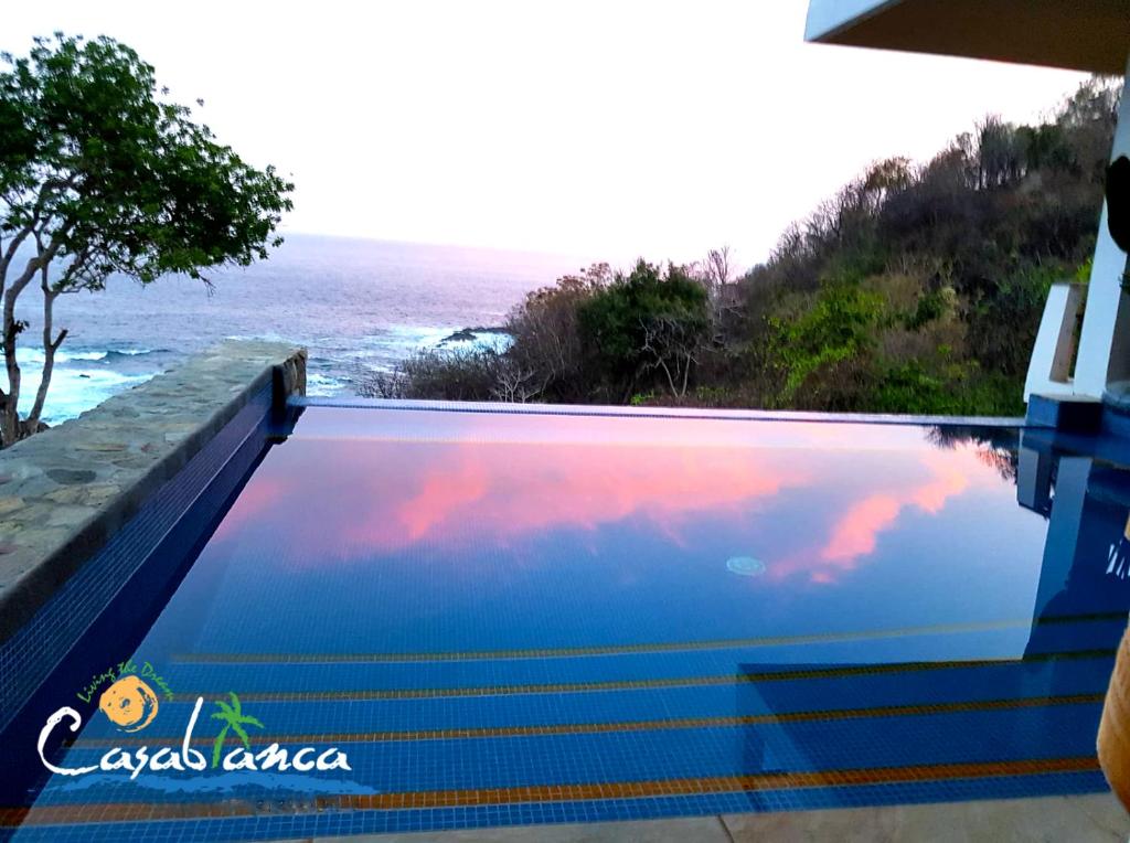 a swimming pool with a view of the ocean at Casablanca Guest House - Adults Only - Starlink Internet! in Zipolite