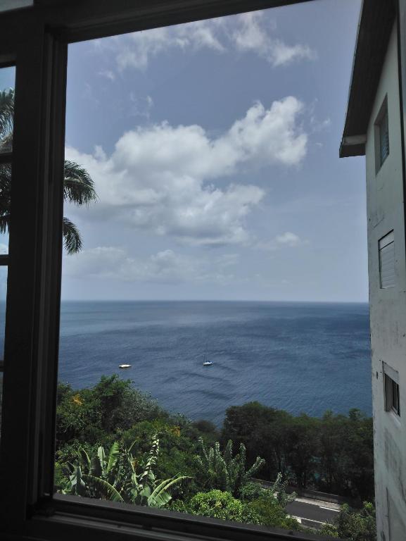 a view of the ocean from a window at L'apparté enchantée in Schœlcher