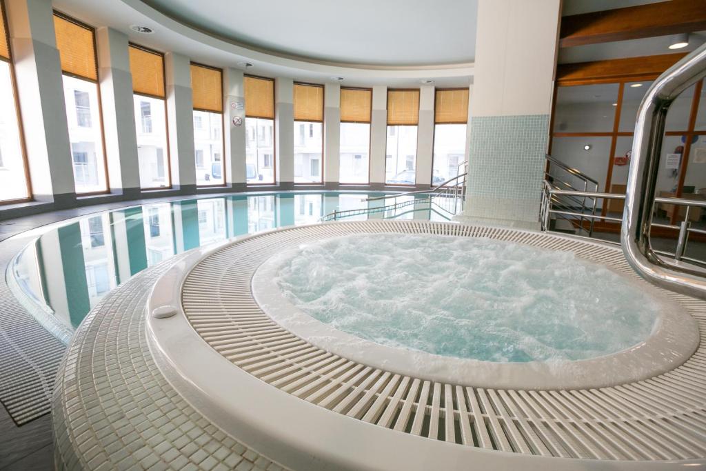 a large swimming pool with a hot tub at VIP Apartamenty Stara Polana in Zakopane
