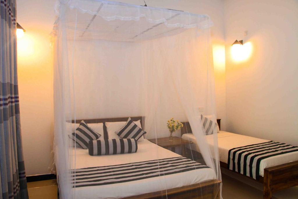 Postel nebo postele na pokoji v ubytování Sigiri Anu Homestay
