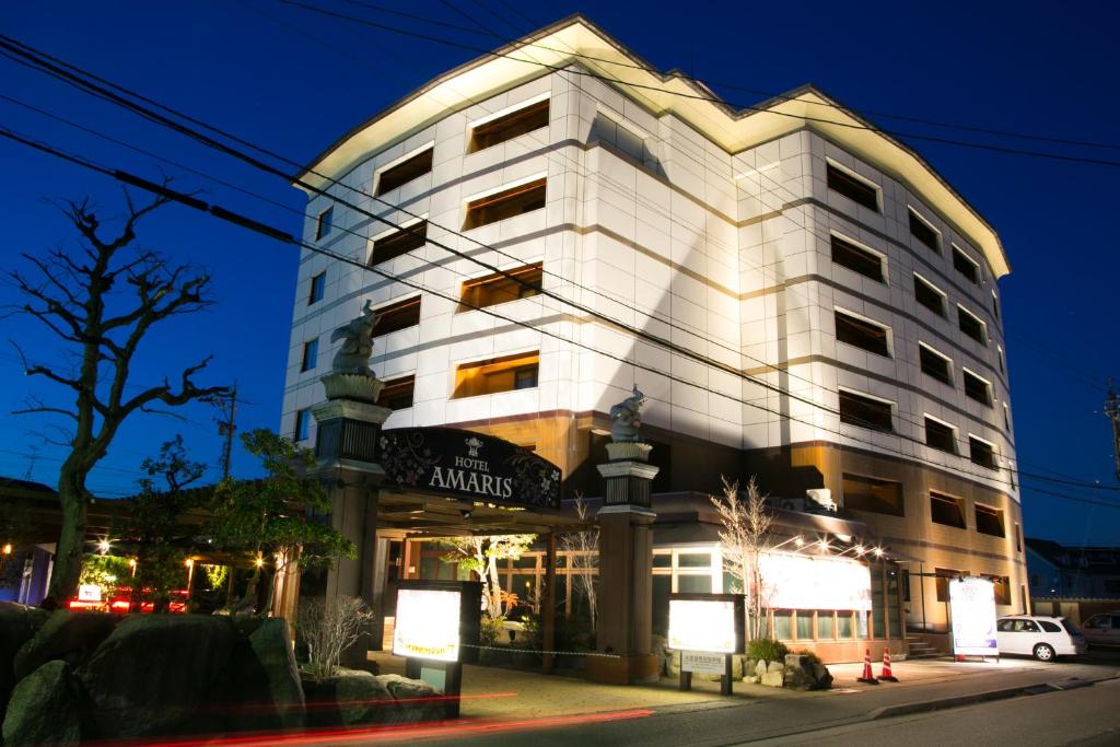 a building on a city street at night at HOTEL AMARIS & HIP (Adult Only) in Kanazawa