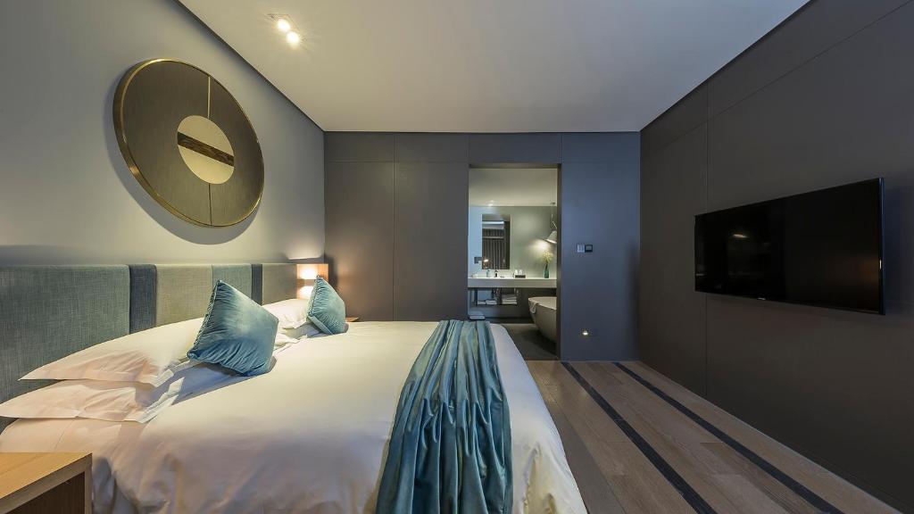 Postel nebo postele na pokoji v ubytování Shanghai Pagoda INNO Hotel