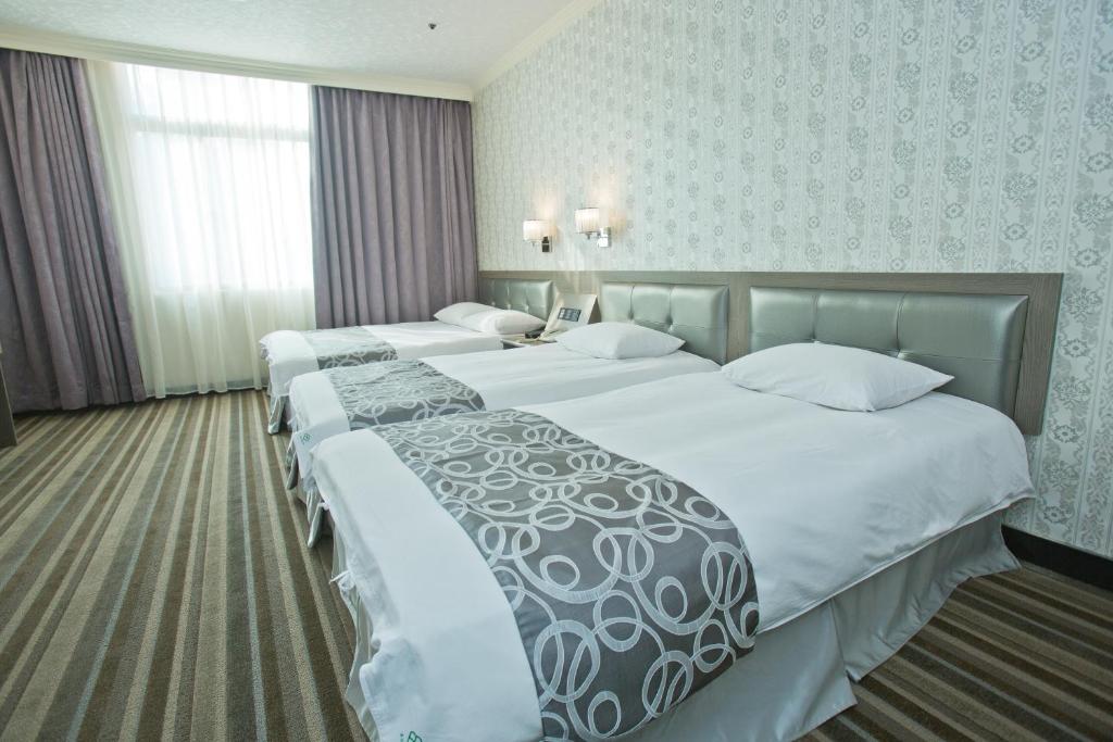 Postel nebo postele na pokoji v ubytování Hotel River Kinmen