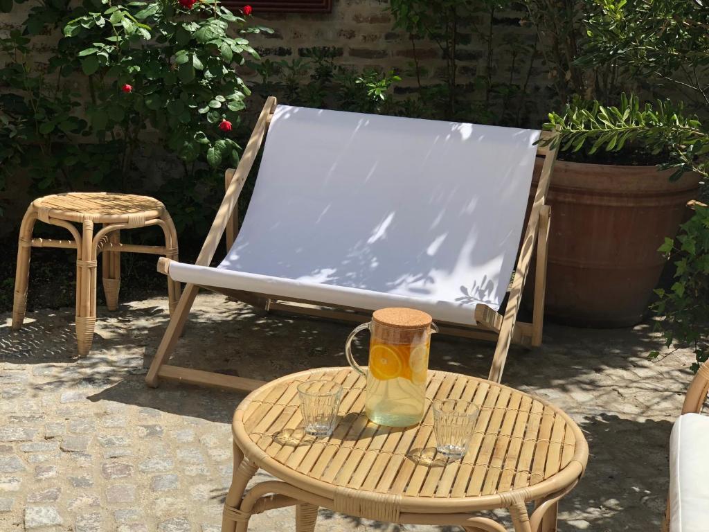 a chair and a table with a vase on it at ibis Styles Paris Nation Cours de Vincennes in Paris