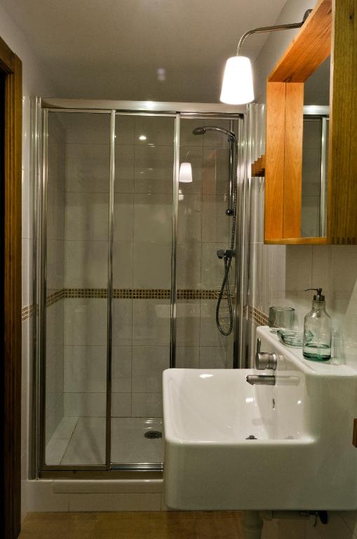 a bathroom with a shower and a sink at Apartamentos Playa Galizano in Galizano