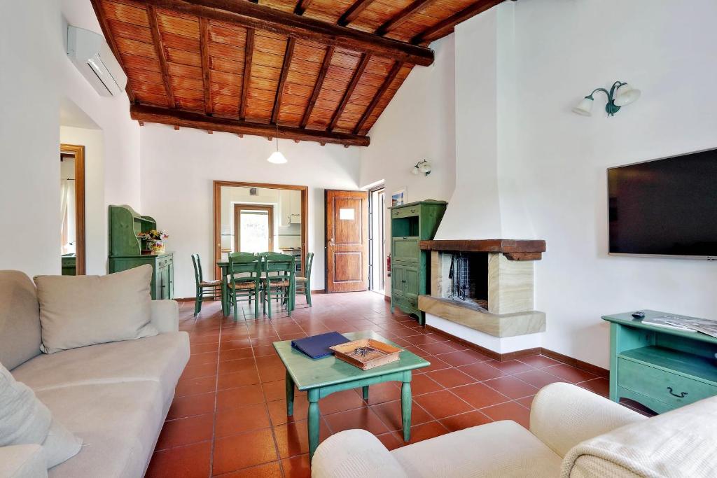 a living room with a couch and a fireplace at Agriturismo Pimpinnacolo in Porto Ercole