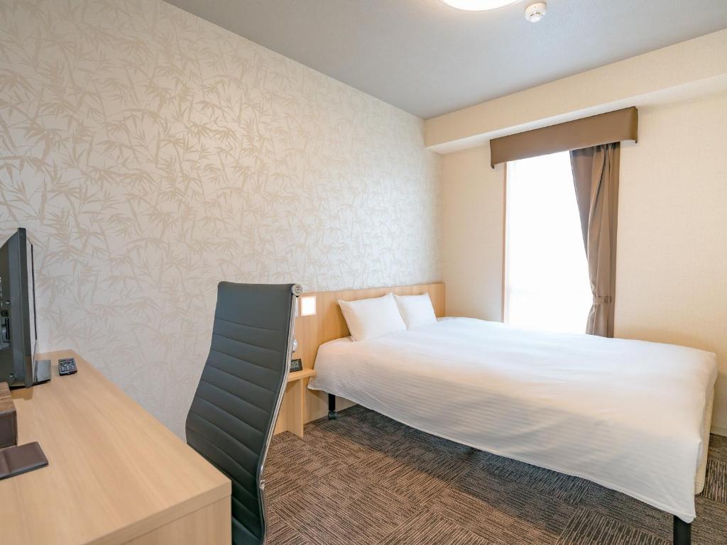Postel nebo postele na pokoji v ubytování TABINO HOTEL Sado