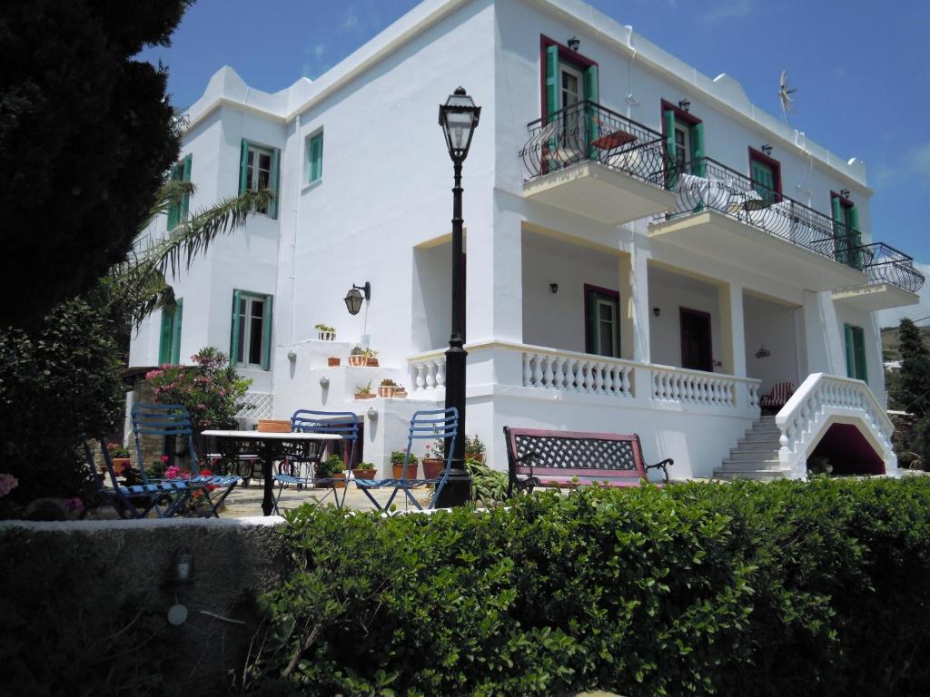 a large white building with a table and a street light at Blue Dolphin in Batsi